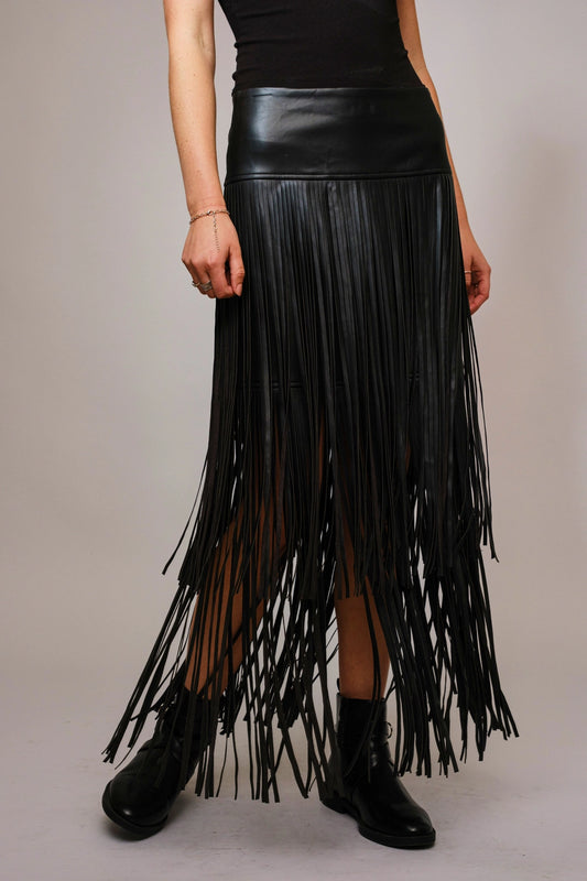 Close-up front view of the black faux leather maxi skirt showing tiered fringe details.